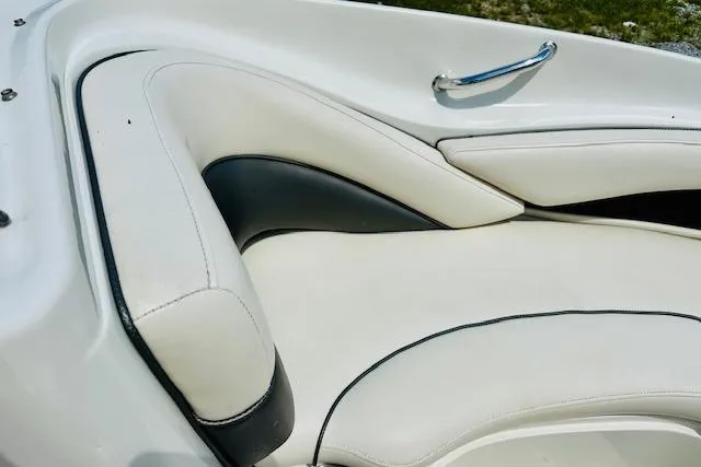 Slide: The Image of 2005 Sea Ray 200 Select boat interior with white cushioned seating. - 12