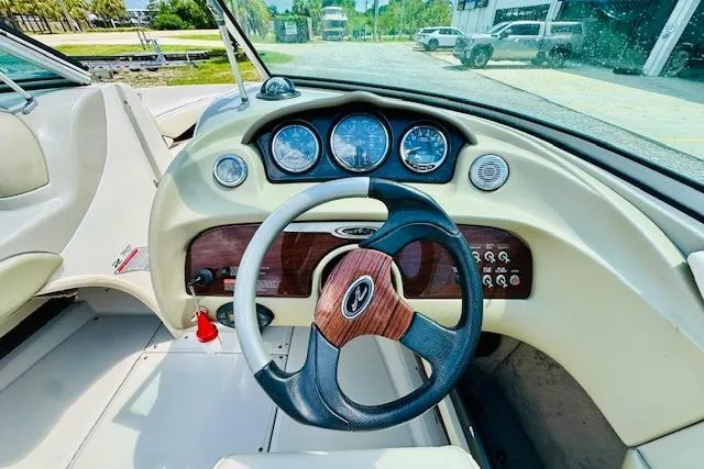 Slide: The Image of 2005 Sea Ray 200 Select boat interior with white and black cushioned seating. - 13