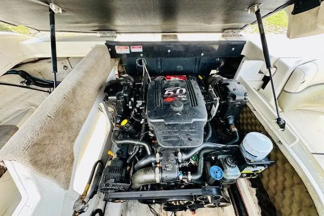 Slide: The Image of 2005 Sea Ray 200 Select boat interior with cup holders and storage compartment. - 15