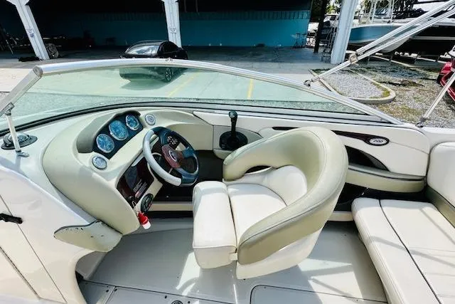 Slide: The Image of 2005 Sea Ray 200 Select boat interior with white cushioned seating. - 8