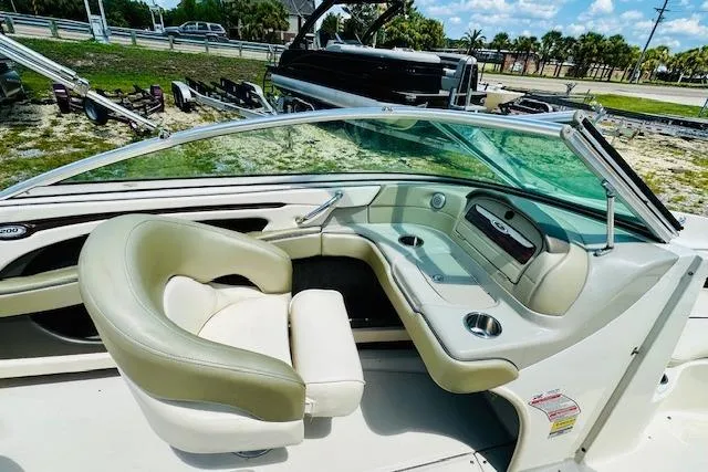 Slide: The Image of 2005 Sea Ray 200 Select boat interior with steering wheel and seating area. - 9