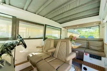 Slide: The Image of Interior of 2018 Axopar 37 XC CROSS CABIN with seating and helm. - 10