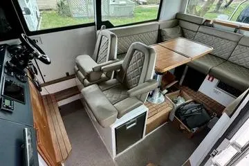 Slide: The Image of 2018 Axopar 37 XC CROSS CABIN interior with seating and table, featuring modern design. - 11