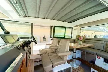 Slide: The Image of Interior of 2018 Axopar 37 XC CROSS CABIN with seating and helm station. - 12