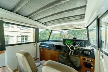 Slide: The Image of 2018 Axopar 37 XC CROSS CABIN interior with modern helm and panoramic windows. - 13