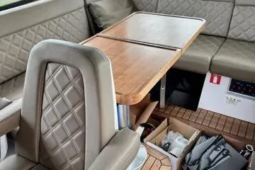 Slide: The Image of 2018 Axopar 37 XC CROSS CABIN interior with wooden table and quilted seating. - 15