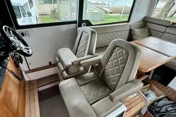 Slide: The Image of 2018 Axopar 37 XC CROSS CABIN interior with plush seating and wooden accents. - 16