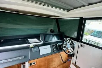 Slide: The Image of 2018 Axopar 37 XC CROSS CABIN interior with modern dashboard and steering wheel. - 17