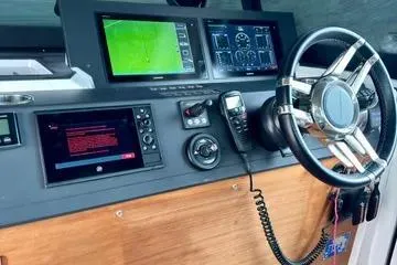 Slide: The Image of Control panel of 2018 Axopar 37 XC CROSS CABIN with navigation screens and steering wheel. - 19