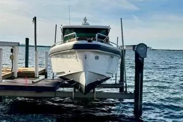 Slide: The Image of 2018 Axopar 37 XC CROSS CABIN boat docked on a sunny day. - 2