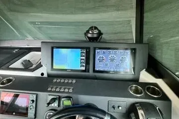 Slide: The Image of 2018 Axopar 37 XC CROSS CABIN dashboard with navigation and control screens. - 21