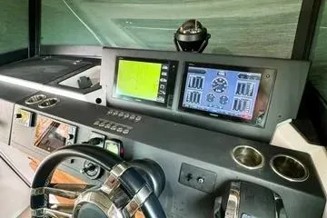 Slide: The Image of 2018 Axopar 37 XC CROSS CABIN dashboard with navigation and control screens. - 22