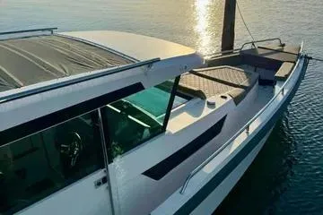 Slide: The Image of 2018 Axopar 37 XC CROSS CABIN boat on calm water at sunset. - 4