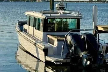 Slide: The Image of 2018 Axopar 37 XC CROSS CABIN boat docked on calm water. - 8