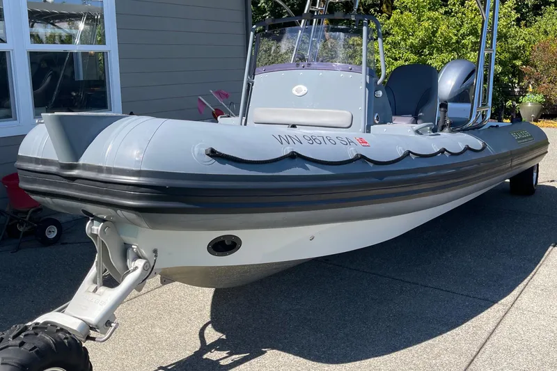 The Image of 2013 Sealegs 7.7 RIB boat with wheels, parked on a driveway. - 0