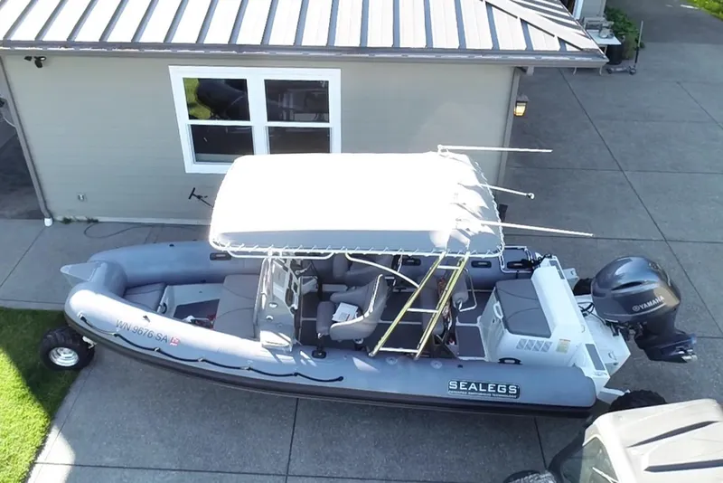 Slide: The Image of 2013 Sealegs 7.7 RIB with canopy, parked on concrete driveway. - 3
