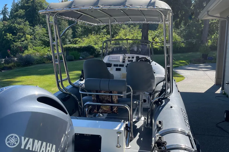 Slide: The Image of 2013 Sealegs 7.7 RIB boat with Yamaha engine, parked in a sunny garden. - 6