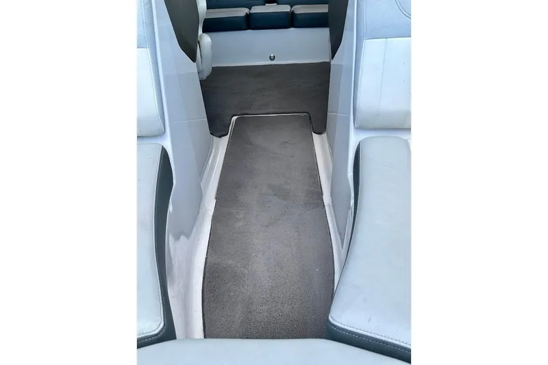 Slide: The Image of Interior view of 2012 Regal 2100 boat with gray carpet and seating. - 32