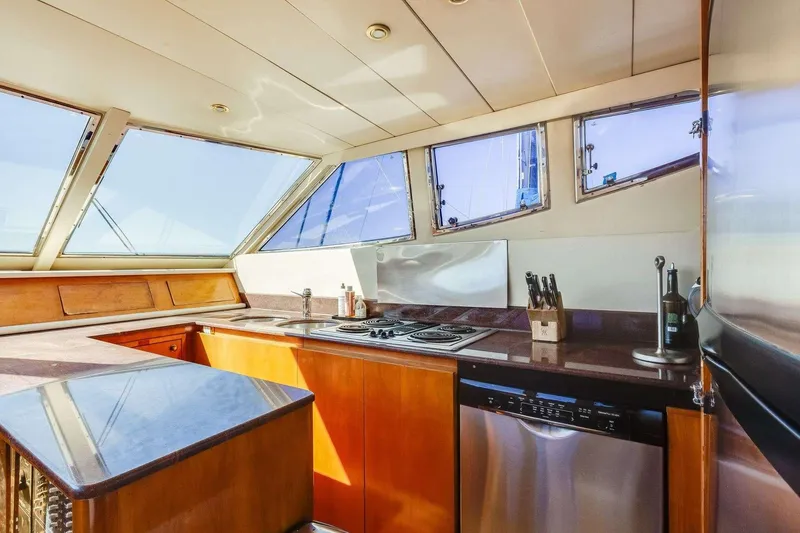 Slide: The Image of Luxurious kitchen interior of 1988 Azimut Motor Yacht with modern appliances and panoramic windows. - 10