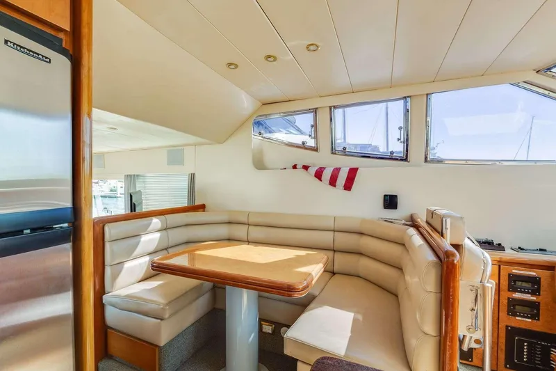 Slide: The Image of 1988 Azimut Motor Yacht interior with cozy dining area and modern amenities. - 12