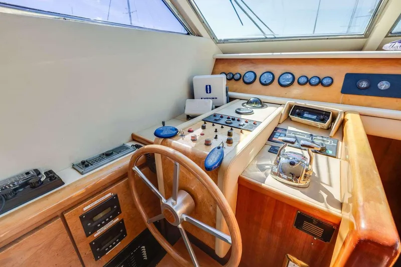 Slide: The Image of 1988 Azimut Motor Yacht helm with wooden steering wheel and control panel. - 13