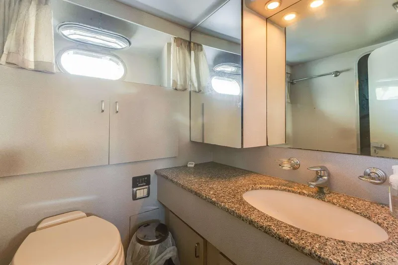 Slide: The Image of Luxurious bathroom in a 1988 Azimut Motor Yacht with granite countertop and modern fixtures. - 14