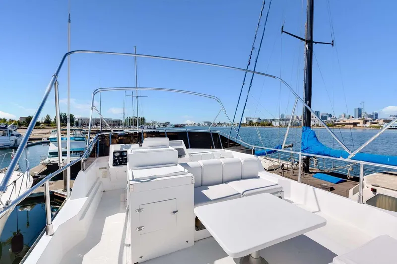 Slide: The Image of 1988 Azimut Motor Yacht deck with seating, docked at marina under clear blue sky. - 21