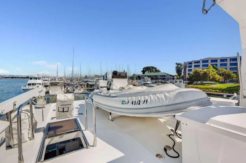 Slide: The Image of 1988 Azimut Motor Yacht docked at marina with inflatable boat on deck. - 22