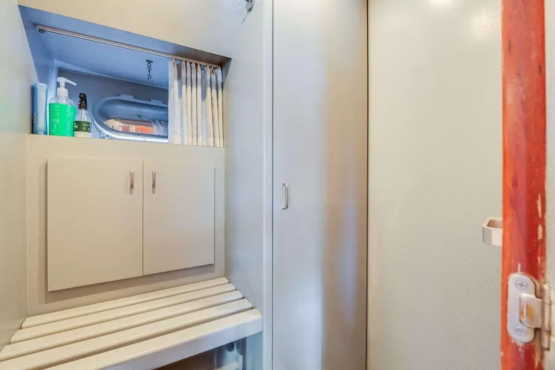 Slide: The Image of 1988 Azimut Motor Yacht interior with storage cabinet and porthole window. - 29