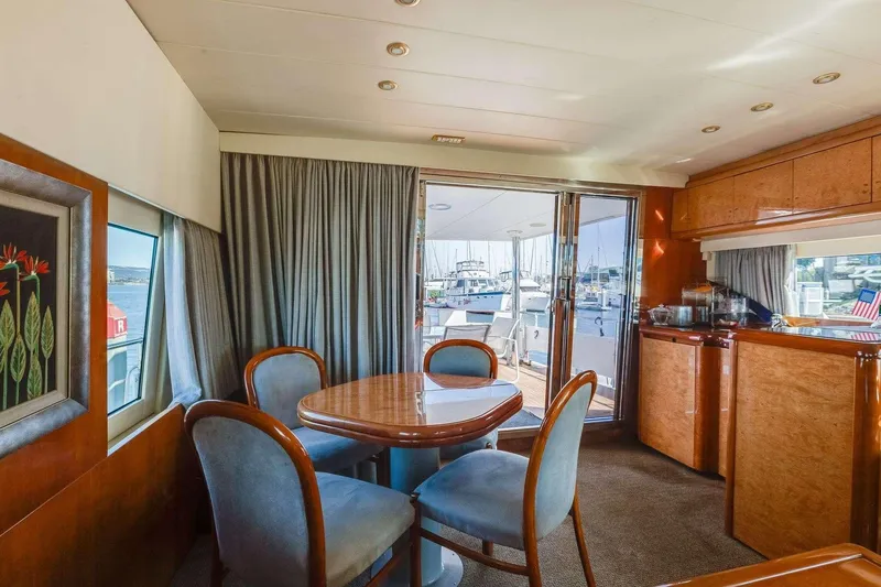 Slide: The Image of Luxurious interior of 1988 Azimut Motor Yacht with elegant dining area and marina view. - 3