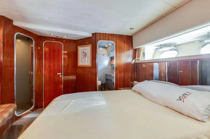 Slide: The Image of Luxurious 1988 Azimut Motor Yacht cabin with elegant wood paneling and cozy bedding. - 31