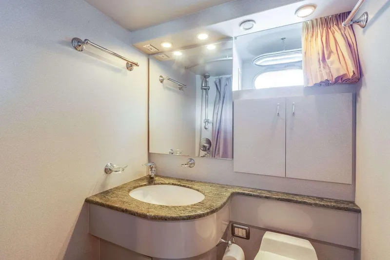 Slide: The Image of Luxurious bathroom in a 1988 Azimut Motor Yacht with modern fixtures and elegant design. - 33