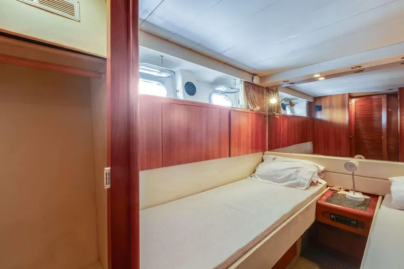 Slide: The Image of 1988 Azimut Motor Yacht cabin with wooden interior and cozy single bed. - 34