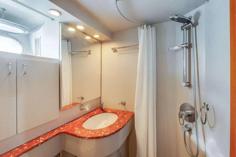 Slide: The Image of Luxurious 1988 Azimut Motor Yacht bathroom with red marble countertop and modern shower. - 36
