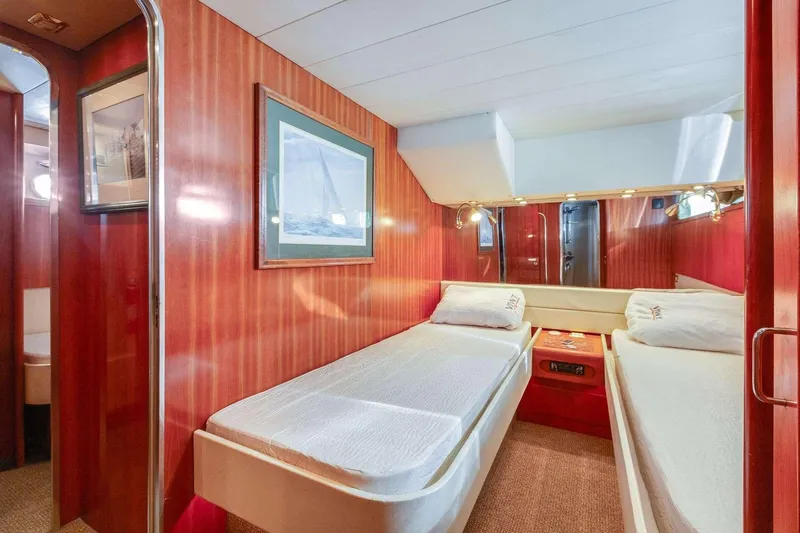 Slide: The Image of Interior of 1988 Azimut Motor Yacht with twin beds and wooden paneling. - 37