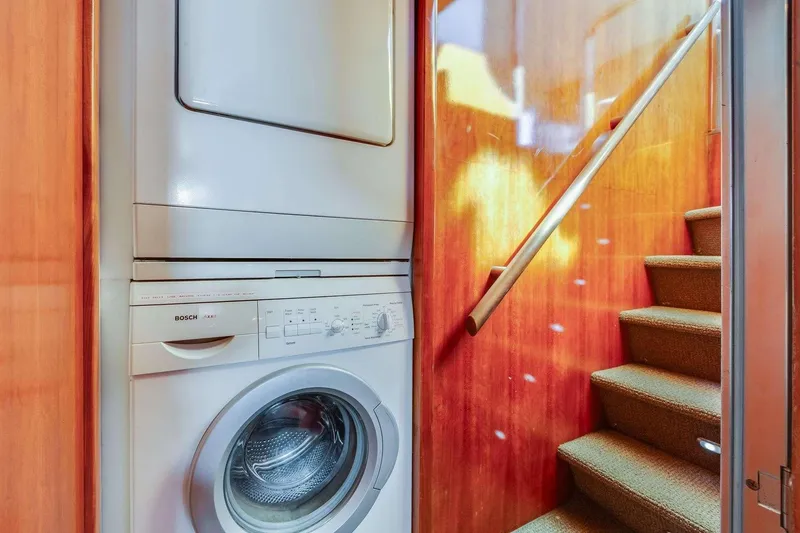 Slide: The Image of Laundry area with Bosch appliances on 1988 Azimut Motor Yacht, near carpeted stairs. - 39