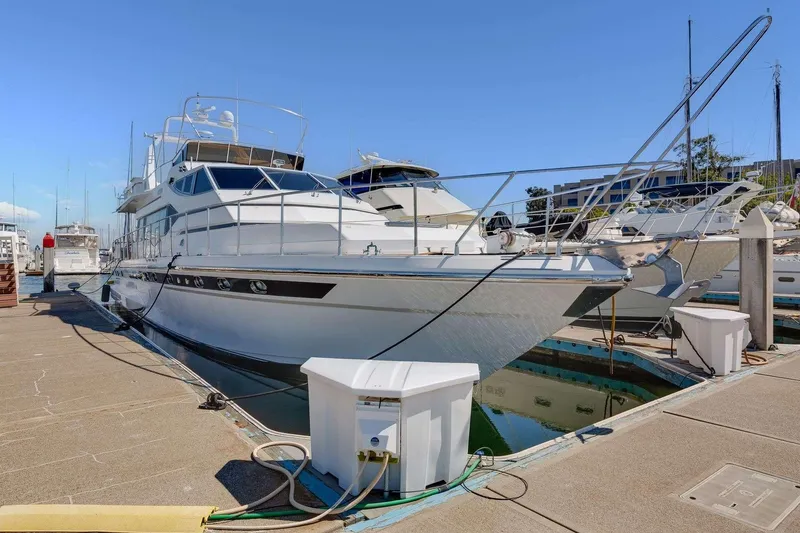 Slide: The Image of 1988 Azimut Motor Yacht docked at marina under clear blue sky. - 45
