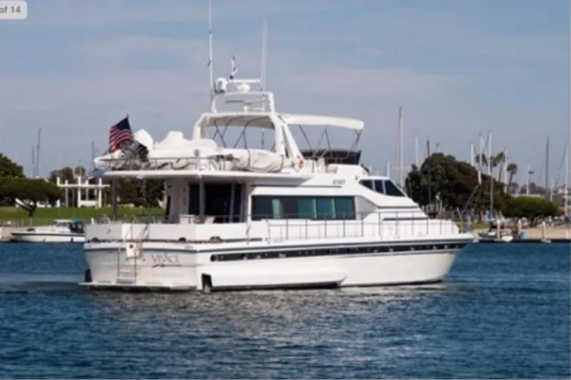 Slide: The Image of 1988 Azimut Motor Yacht cruising in a marina with American flag. - 47