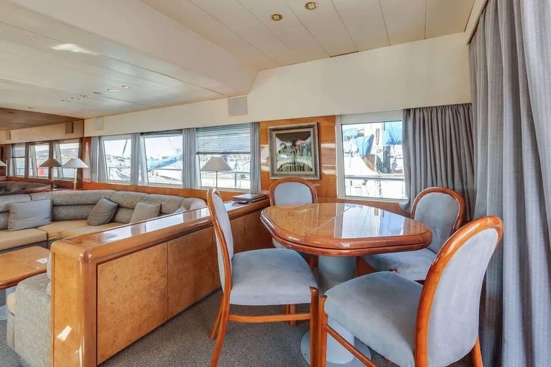 Slide: The Image of Luxurious 1988 Azimut Motor Yacht interior with elegant dining area and plush seating. - 5