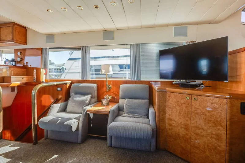 Slide: The Image of Luxurious 1988 Azimut Motor Yacht interior with cozy seating and modern TV setup. - 7