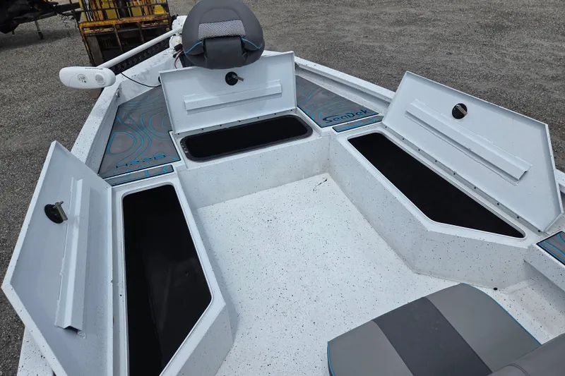 Slide: The Image of 2022 Xpress H22B boat interior with open storage compartments and seating. - 10