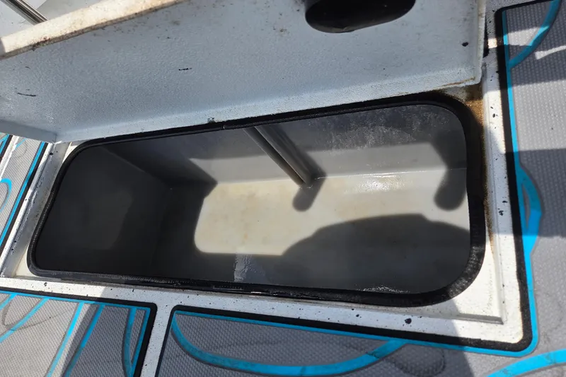 Slide: The Image of Open storage compartment on 2022 Xpress H22B boat, showing interior details. - 12