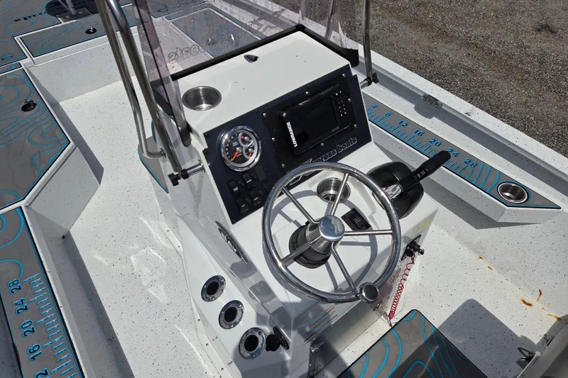Slide: The Image of 2022 Xpress H22B boat console with steering wheel, gauges, and controls. - 17