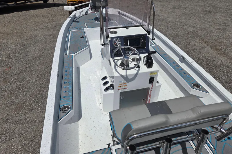 Slide: The Image of 2022 Xpress H22B boat interior with steering console and seating, featuring modern design elements. - 18