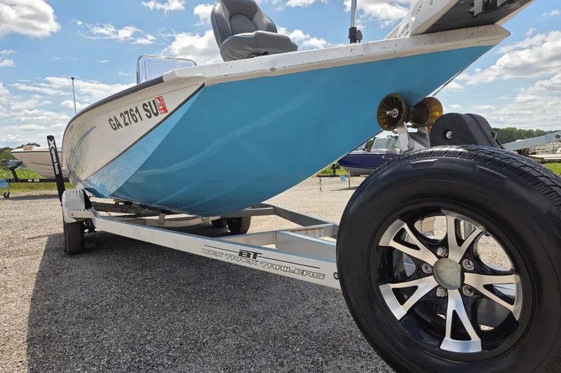 Slide: The Image of 2022 Xpress H22B boat on trailer, blue hull, sunny day, close-up view. - 3