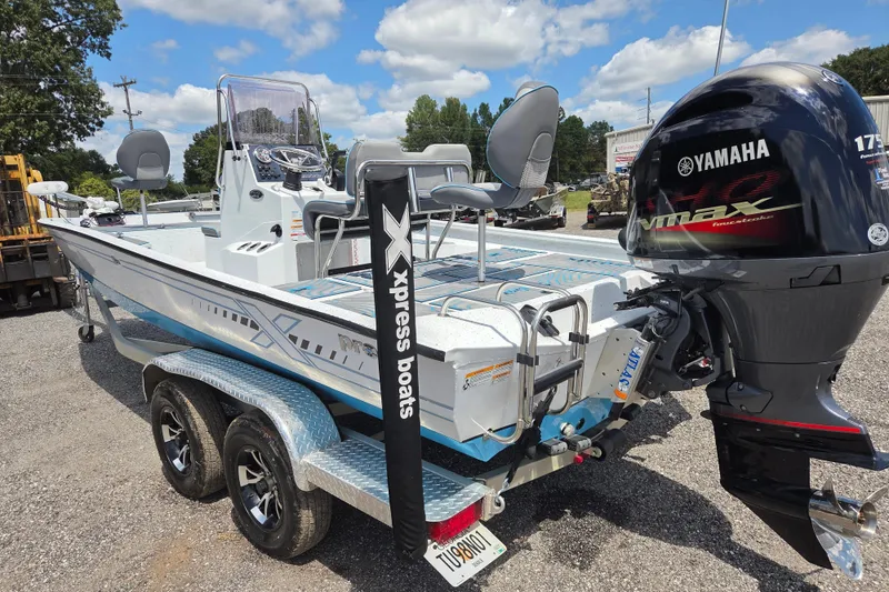 Slide: The Image of 2022 Xpress H22B boat with Yamaha VMAX engine on a trailer, parked outdoors. - 7