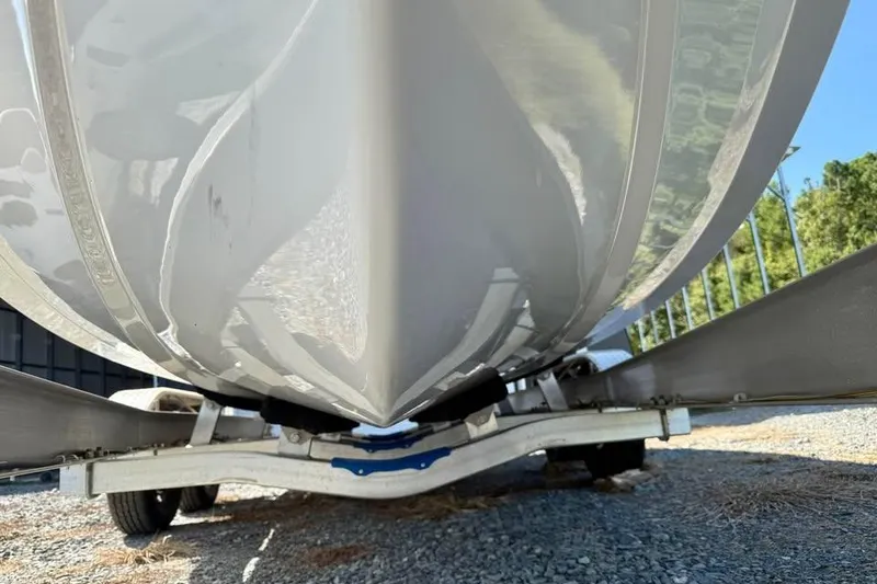 Slide: The Image of 2026 Sea Hunt Ultra 235 SE boat hull on trailer, close-up view. - 12