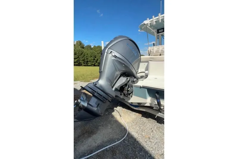 Slide: The Image of 2026 Sea Hunt Ultra 235 SE boat with powerful outboard motor in a scenic outdoor setting. - 5