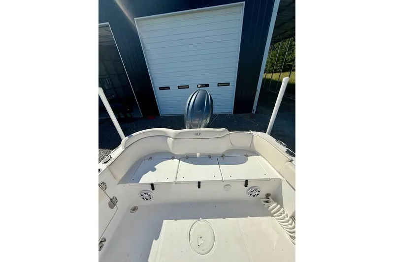 Slide: The Image of 2026 Sea Hunt Ultra 235 SE boat interior with storage compartments and speakers. - 6