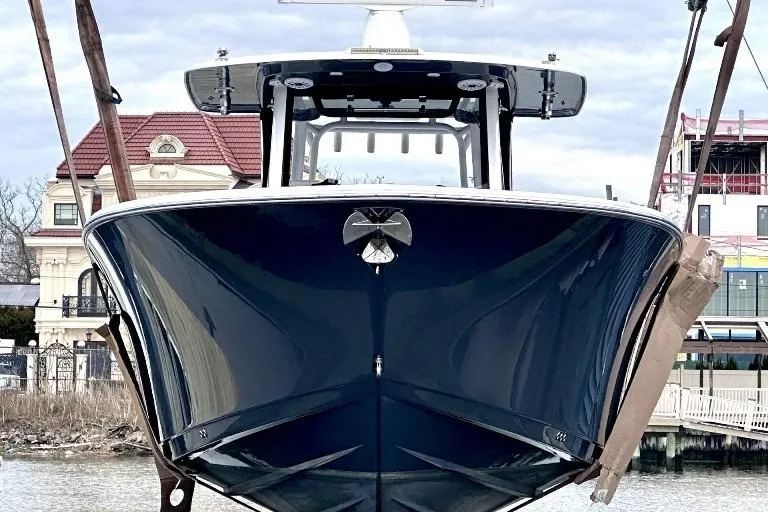 Slide: The Image of 2022 Sportsman Open 352 Center Console boat in dry dock, front view. - 2